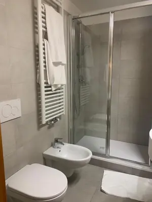 a bathroom with a shower and a toilet and a sink at casa canazei in Alba di Canazei