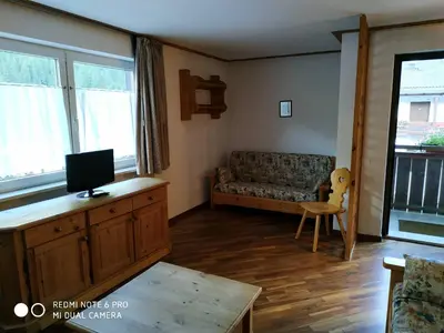 a living room with a couch and a tv at casa canazei in Alba di Canazei
