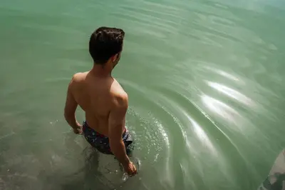a young man standing in the water at Nikolausberg - Hof im Garten in Caldaro