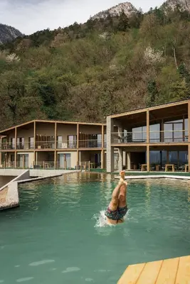 a man in the water in a swimming pool at Nikolausberg - Hof im Garten in Caldaro
