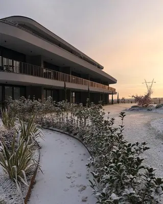 a building with snow on the ground in front of it at Belia Lofts - ADULTS ONLY - Apartments in Appiano sulla Strada del Vino