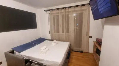 a small room with a bed with two towels on it at Studio Apartment Ariston in centro a Cortina in Cortina dʼAmpezzo