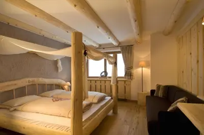 a bedroom with a bunk bed in a room at Hotel Piz Seteur in Selva di Val Gardena