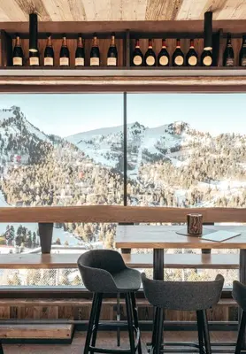 a room with a large window with a table and chairs at Hotel Piz Seteur in Selva di Val Gardena