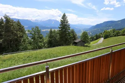 a view of a hill with a fence and a house at Haus Waldruhe in Villandro