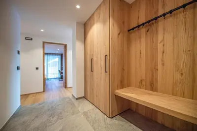 a room with wooden cabinets and a hallway at apartment allium in Selva di Val Gardena