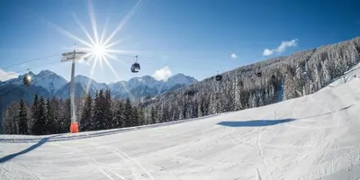 a snow covered ski slope with a ski lift at B&B Villa Dolomites Hut in San Vigilio Di Marebbe