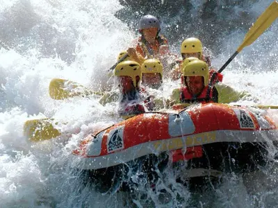 a group of people in a raft in the water at B&B Villa Dolomites Hut in San Vigilio Di Marebbe