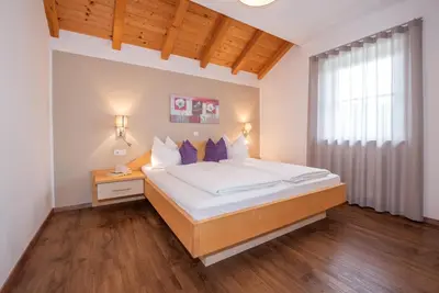 a bedroom with a bed and a window at Leuchtenhof in Caldaro