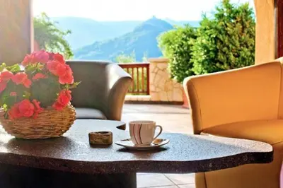 a table with a cup of coffee and a basket of flowers at Leuchtenhof in Caldaro