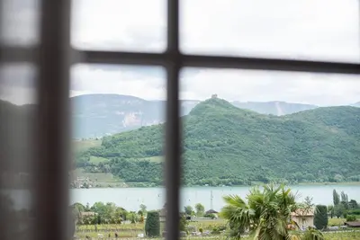 a view of a lake from a window at Leuchtenhof in Caldaro
