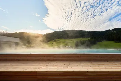 a window with a view of a lake and mountains at Berghotel in Racines