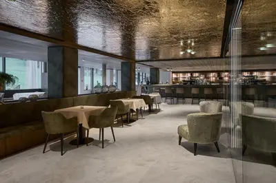 a restaurant with tables and chairs and a bar at Berghotel in Racines