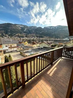 a balcony with a view of a town at Suan Hut in Ziano di Fiemme
