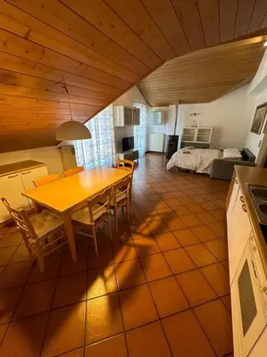 a kitchen and dining room with a table and chairs at Suan Hut in Ziano di Fiemme