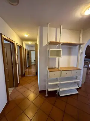 a room with an empty room with shelves and a hallway at Suan Hut in Ziano di Fiemme