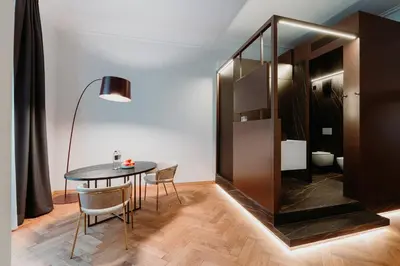 a dining room with a table and chairs and a mirror at META SUITES historic city living in Bolzano