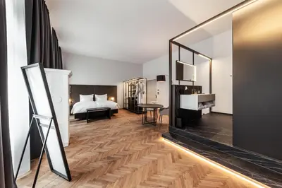 a hotel room with a bed and a mirror at META SUITES historic city living in Bolzano