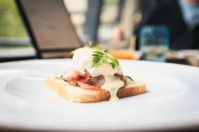 a piece of food on a white plate on a table at META SUITES historic city living in Bolzano