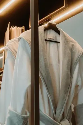 a robe hanging on a rack in a closet at META SUITES historic city living in Bolzano