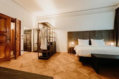 a hotel room with a bed and a bathroom at META SUITES historic city living in Bolzano