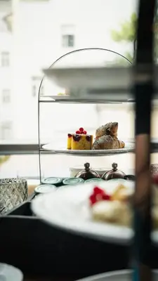 a table with a plate of food on a shelf at META SUITES historic city living in Bolzano