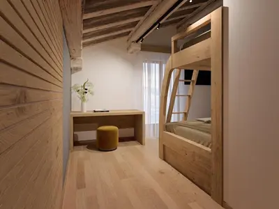 a bedroom with a bunk bed and a desk at Naturae Lodge Wellness & Spa in Alleghe