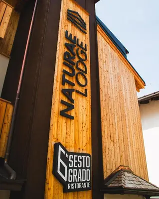 a scientology sign on the side of a building at Naturae Lodge Wellness & Spa in Alleghe