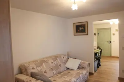 a living room with a couch and a table at Casa Sirena in Canale dʼAgordo