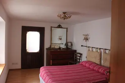 a bedroom with a bed and a dresser and a mirror at Casa Sirena in Canale dʼAgordo