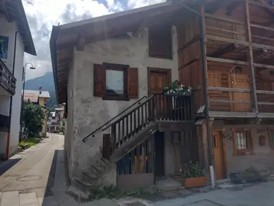 a building with a staircase on the side of it at Casa Sirena in Canale dʼAgordo