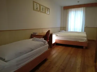 a bedroom with a bed on a wooden balcony at Lumen in Falcade