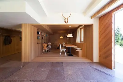 a kitchen and dining room with a table and chairs at Lumen in Falcade