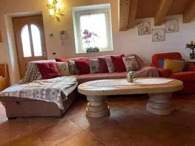 a living room with a couch and a table at Bella Vista in Canale San Bovo