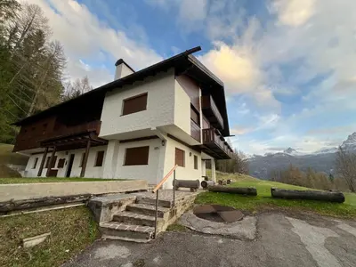 a house that is on top of a hill at Mansarda a Cortina in Cortina dʼAmpezzo