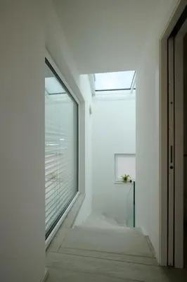 a white hallway with a window and a skylight at SWEETHOME MUSEO - con Garage in Bolzano