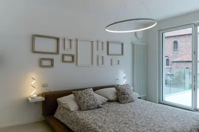 a bedroom with a bed and a flat screen tv at SWEETHOME MUSEO - con Garage in Bolzano