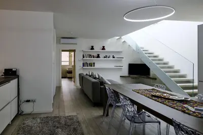a living room with a couch and a staircase at SWEETHOME MUSEO - con Garage in Bolzano