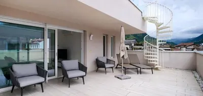 a balcony with a table and chairs and a view at SWEETHOME MUSEO - con Garage in Bolzano