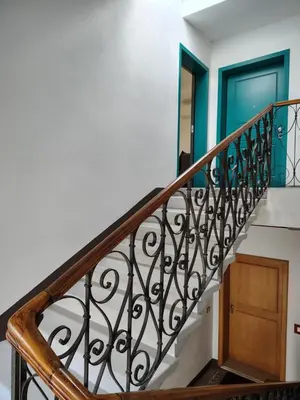 a staircase with a blue door and a blue door at Villa Bregenz Apartment in Merano
