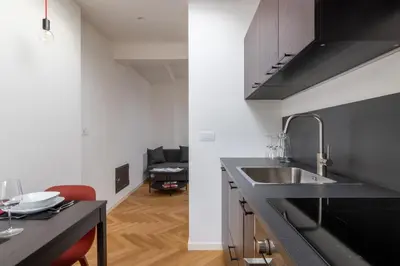 a kitchen with a sink and a counter top at Villa Bregenz Apartment in Merano