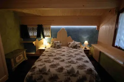 a bedroom with a large bed in a room at Chalet Pra Dell OSTIO Primiero San Martino di Castrozza in Fiera di Primiero