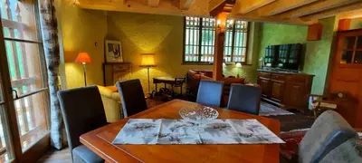 a dining room with a wooden table and chairs at Chalet Pra Dell OSTIO Primiero San Martino di Castrozza in Fiera di Primiero