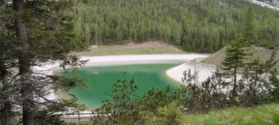 a view of a lake in the middle of a forest at Appartamenti Codàn in San Vito di Cadore