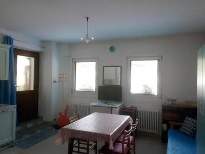 a living room with a table and a television at Appartamenti Codàn in San Vito di Cadore