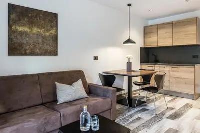 a living room with a couch and a table at Sole Boutique Hotel in Vipiteno