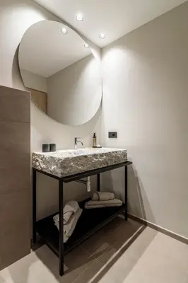 a bathroom with a sink and a mirror at Sole Boutique Hotel in Vipiteno