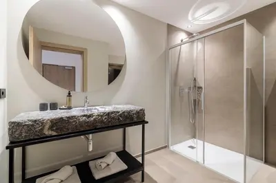 a bathroom with a sink and a shower at Sole Boutique Hotel in Vipiteno