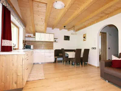 a kitchen and dining room with a table and chairs at Villa Hilde in San Cassiano