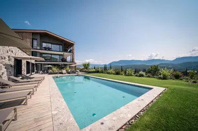 a swimming pool in the backyard of a house at View - AgriSuites in Caldaro